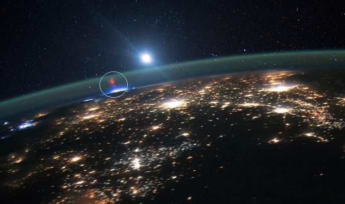 "Red lightning" sprites imaged from the ISS: captured on August 10th, this picture shows elusive "red lightning" sprites occurring high in Earth's atmosphere above a thunderstorm (the bright area directly under them) in the mid-west USA. The surrounding yellowish lights are from towns and cities - image: NASA / JSC